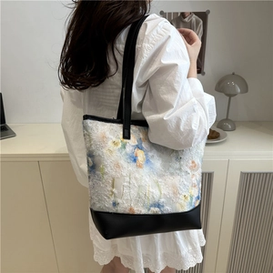 Large floral tote bag with blue and orange plush fabric and black leather straps