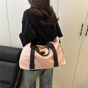 Large pale pink waterproof travel tote bag with black straps for summer travel