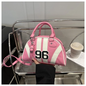 Detail of pink and white shell bag with 96 patch embroidery and star accents