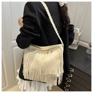 Détail du sac cabas blanc cassé avec franges double couche et poignée tressée épaisse