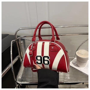 Detail of red bowling bag with white trim, 96 applique and star metallic studs