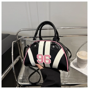 Detail showing shell-shaped bag with number 96 patch and star rivets in hand