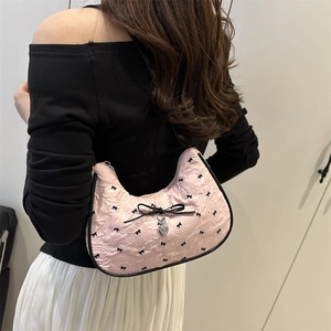 Pink crescent cloud bag with pleated texture and black bow print, silver heart charm