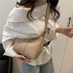 Chic khaki bucket bag for women shown with a model for stylish daily commute wear
