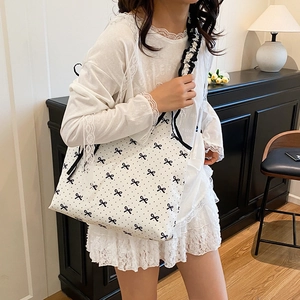 White shoulder tote bag with black bow print and pleated ruffle strap for casual summer