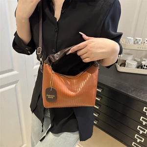 Orange pleated leather bucket bag with brown handles and gold hardware for women