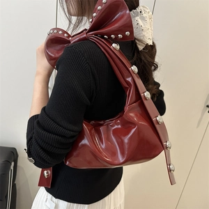 Sac croissant en cuir verni rouge à grand nœud et rivets argentés élégants