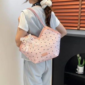 Pink pleated tote bag with black bow prints and a delicate pearl lace pendant