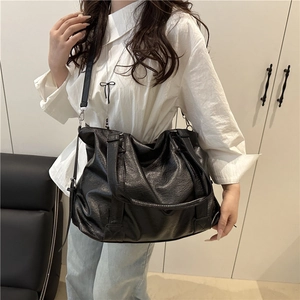 Chic black oversized tote bag in lychee pattern leather with adjustable shoulder strap