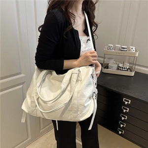 Minimalist white leather tote bag with large capacity and adjustable shoulder strap
