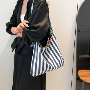 Blue and white striped canvas tote bag with geometric straps for summer daily commute