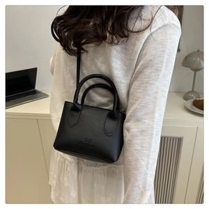 Litchi pattern black mini crossbody bag with DX Do&think logo shown on a model