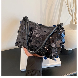 Detail of high-density black sequin texture on modern shoulder bag with zipper