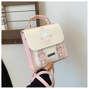 Detail of the pink and beige leather backpack featuring a cute white cartoon cat print