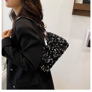 Close-up of stylish black sequin shoulder bag with detailed texture and leather strap