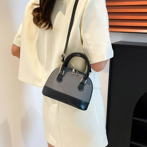 Chic shell-shaped crossbody bag in textured grey fabric with black leather handles