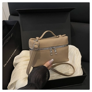 Brown litchi grain leather box bag inside a gift box with a silver double zipper detail