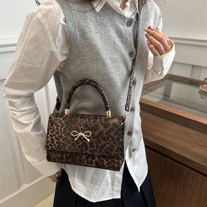 Chic leopard print crossbody square bag with golden bow accent and top handle