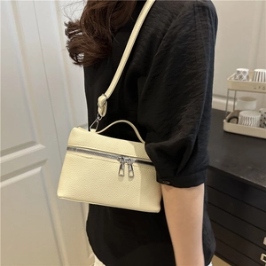 Chic off-white lychee grain leather crossbody bag with silver double zippers and top handle
