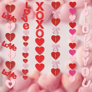 Detailed view of Valentine hanging heart garlands with Love, XOXO text and pink bows
