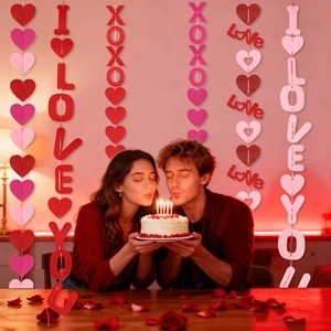 Close-up of Valentine heart garlands with I Love You and XOXO text for party decor