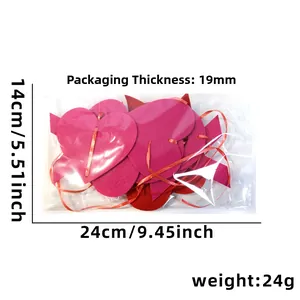 Macro detail of red felt heart garlands and ribbon in 24x14cm packaging for party decor