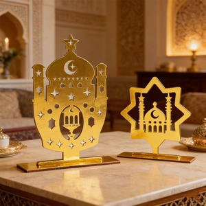 Golden acrylic Eid mosque silhouette and octagonal star desk ornaments on marble