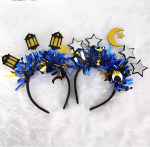 Detail of blue tinsel headbands with gold moon, silver star and black lantern decorations