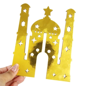 Detail of golden mirror finish moon festival ornament with laser-cut star and castle patterns