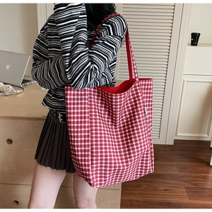 Red and white checkered canvas tote bag with large capacity shown in a lifestyle setting