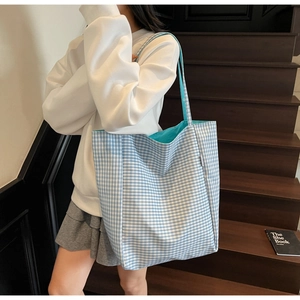 Blue and white gingham tote bag with turquoise interior shown on a shoulder strap