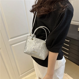 Silver snakeskin texture bucket bag with top handle and FASHION logo strap detail
