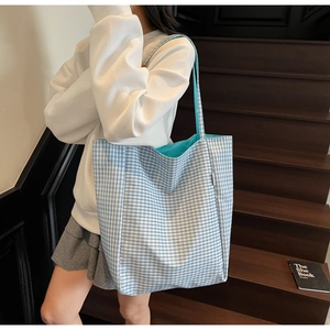 Detail of the blue gingham tote bag showing spacious interior with bright blue lining