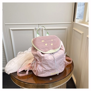 Detailed view of pink guava-themed backpack made of lightweight nylon with embroidery