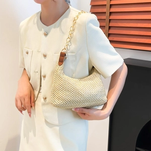 Minimalist straw woven crescent tote bag with gold chain strap for summer beach vacation