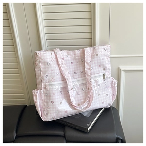 Detail of pink polka dot tote bag with a clear PVC pocket and star pattern