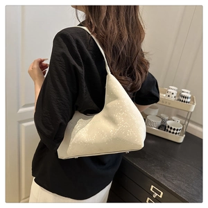 Close-up of off-white hobo bag showing snake-embossed texture and fashion bags stamp