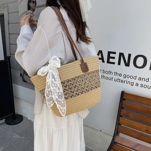 Large khaki straw shoulder bag with leather straps and lace ribbon for summer beach vacations