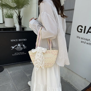 Summer straw tote bag with colorful polka dots and white lace bow for beach vacation