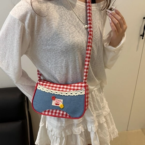Sweet Japanese cherry plaid crossbody bag shown from a side view on a model