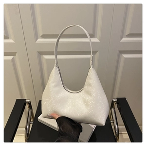 Close-up of white embossed snake-texture PU leather underarm bag with fashion logo