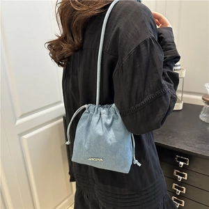 Chic light blue denim drawstring bucket bag with JINGPIN logo and long shoulder strap