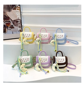 Selection of mini square crossbody bags with cherry prints and plush moon charms