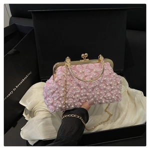 Detail of pink floral evening bag with lace flowers, pearls and golden metal handle