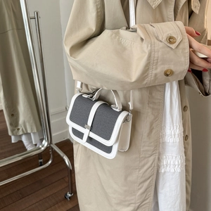 Minimalist two-tone leather crossbody bag with gray texture and white frame handle