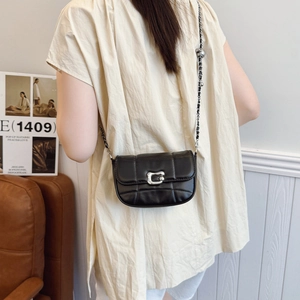 Quilted black saddle bag with C-shaped silver buckle and metal chain shoulder strap