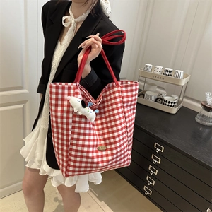Red and white checkered canvas tote bag with red strap and a cute puppy plush charm