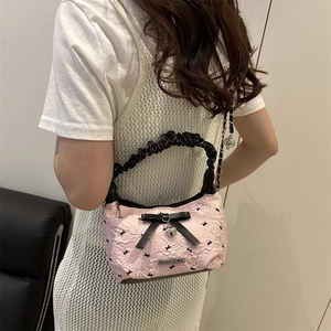 Pink embossed shoulder bag with black bow and heart pendant in a chic girl style