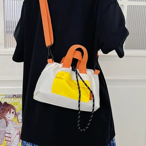 Stylish color-block canvas tote bag in white, yellow, and orange with adjustable strap