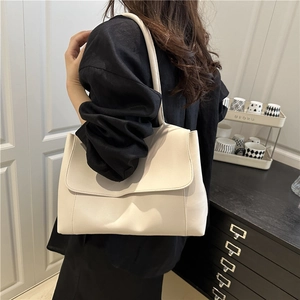 Minimalist beige leather tote bag with large capacity and flap closure for daily commuting